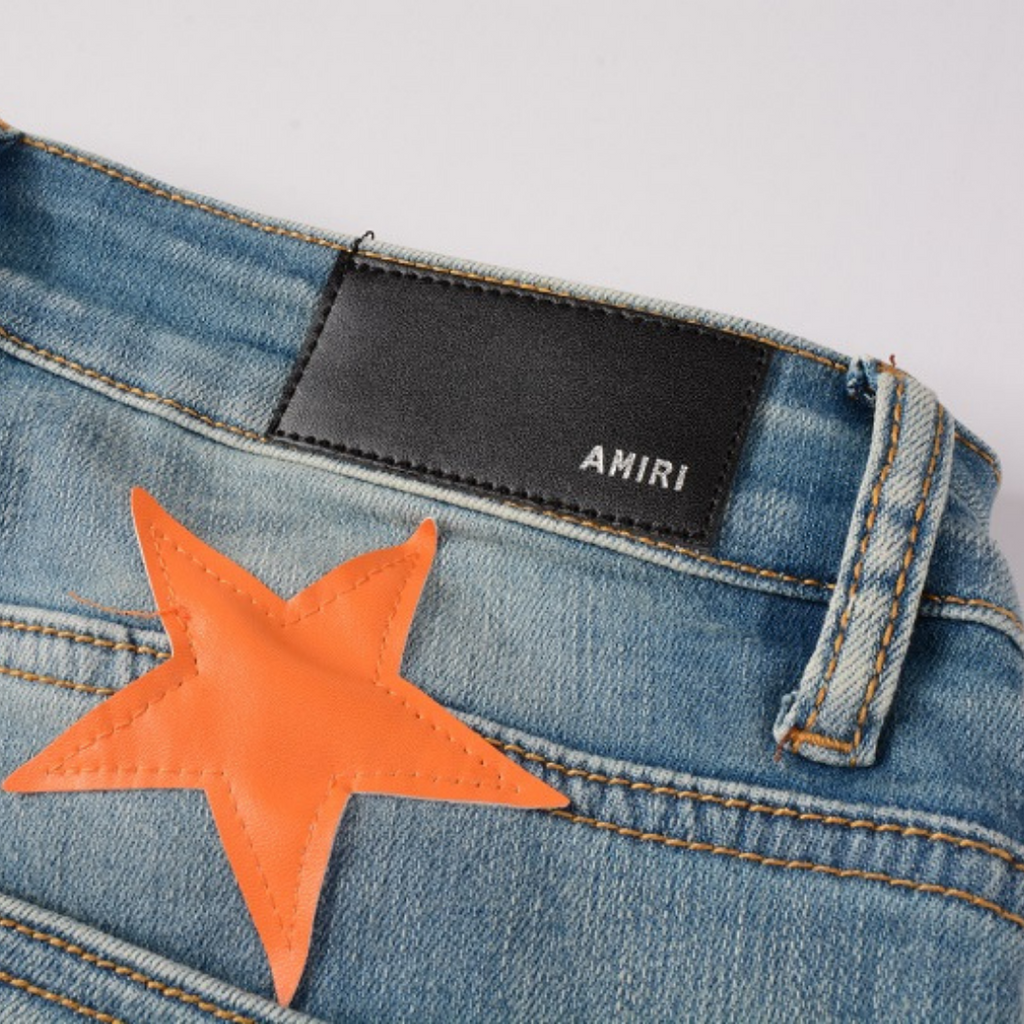 Amiri Slim Fit Designer Jeans mit Orangefarbenen Stern-Patches für Herren
